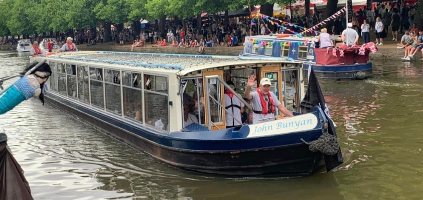 John Bunyan community boat with people travelling on it.