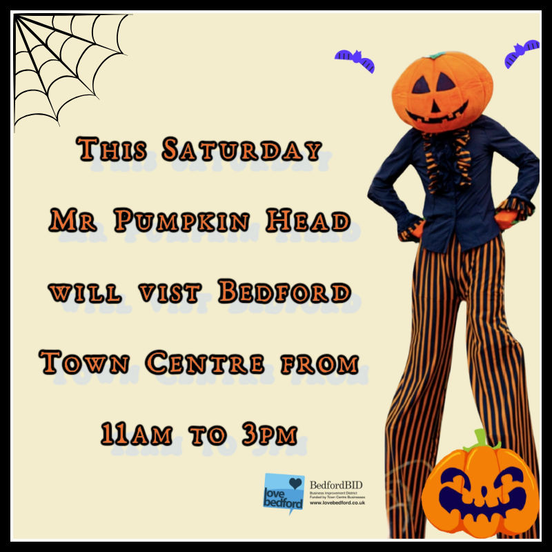 Mr Pumpkin Head image of a stilt walker with a pumpkin Head.