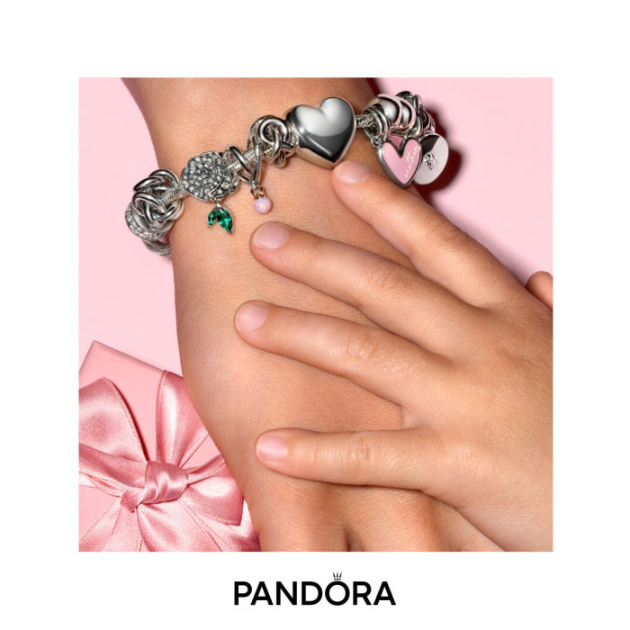 ladies hand with a silver bracelet and a small child's hand