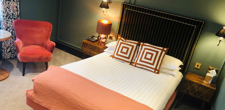 Bedford Swan Hotel bedroom with green walls, timber period bed and geometric cusions
