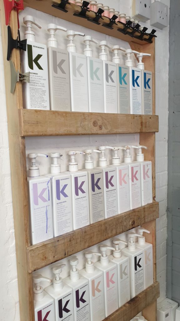 EI Styling Kevin Murphy products on wooden shelves