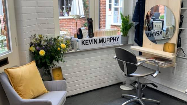 EI Styling shop with grey and yellow soft furnishings, customer chair and mirror