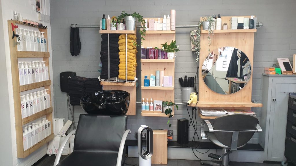 EI Styling hair wash station next to cutting chair and mirror