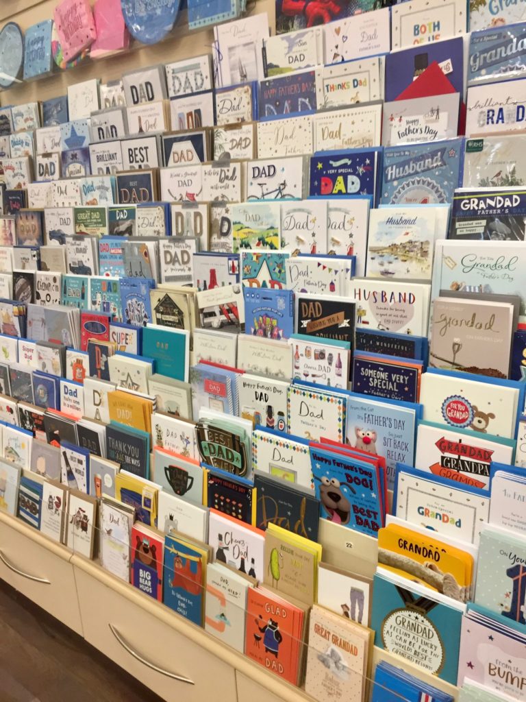 Large selection of gift cards, variety of colours,shapes and sizes all displayed on card racks.