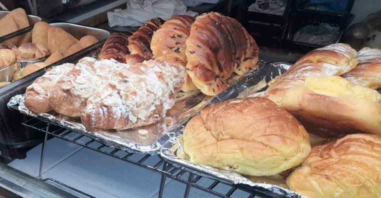 Aconchego trays of croissants, Portuguese breads and pastries