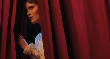 Swan Murder Mystery girl peering out of red curtain