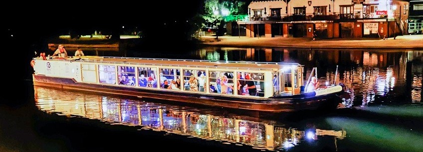 John Bunyan boat on the river in the evening with pretty lights